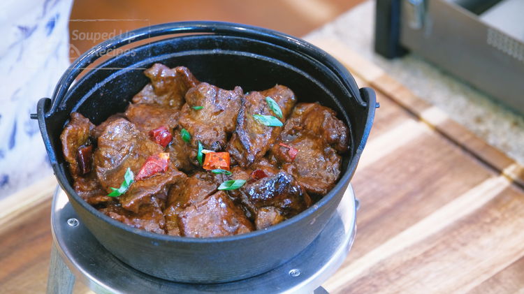 Image of Light a fondue set and continue to heat the cast-iron...