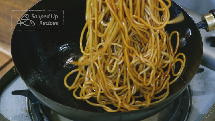 Image of Remove the noodles from the water and shake off the excess moisture. Add the noodles to the hot wok and mix thoroughly with the sauce.