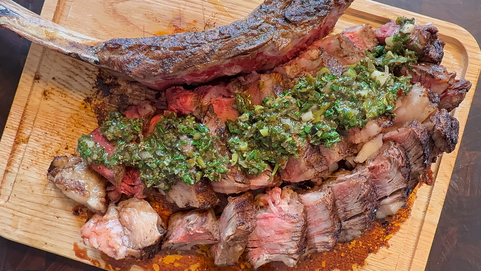 Sliced Tomahawk steak with chimichurri