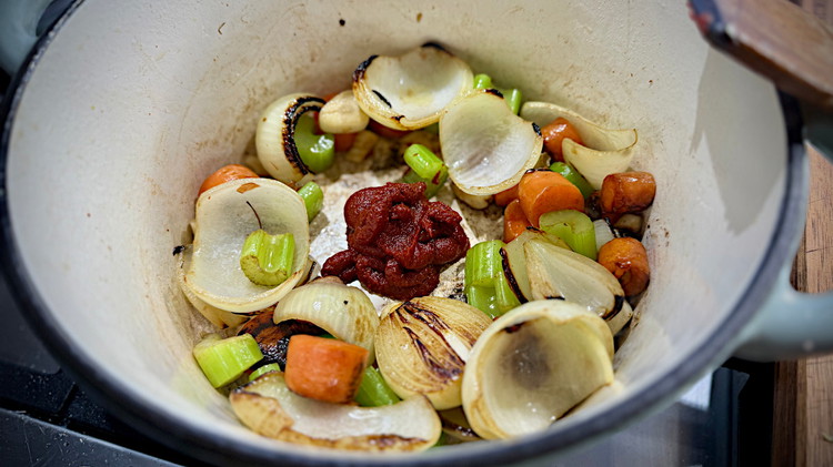 Image of In a large crock pot/casserole dish, bring up to heat on med/high. Once it starts to lightly smoke add beef tallow and cook of onion and carrot. Once they develop colour add remaining veggies and do the same. Then create...
