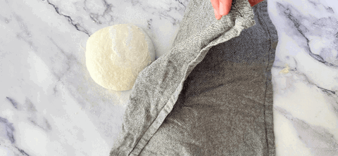 Image of Dust tops with flour and cover with a clean tea towel. Leave to rest for 30 minutes.