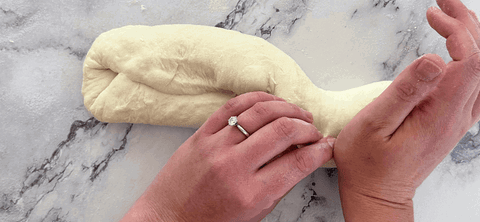 Image of Then, using you left hand take the top edge of the dough and bring it down the meet the bottom edge, use the palm of your right hand to create a seal. Do this along the whole edge of the...