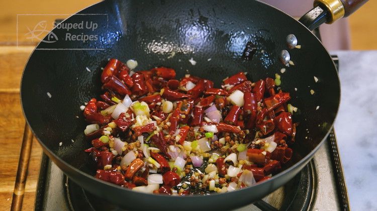 Image of Clean the wok and add 1.5 tbsp of fresh oil, the soaked red chilies, and Sichuan peppercorns. Stir over medium heat for a few minutes or all the moisture is evaporated. Toss in the diced garlic, ginger, shallot and continue...