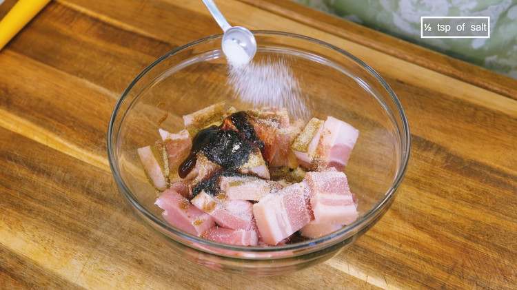 Image of Cut the skin-on pork belly into bite-size pieces and marinate it with 1/2 tsp of five-spice powder, 1 tsp of garlic powder, 1 tbsp of soy sauce, 2 tsp of oyster sauce, 2 tsp of dark soy sauce, and 1/2 tsp...