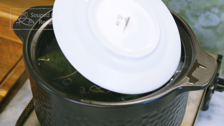 Image of Fill a big pot with water and bring it to a boil. Drop in your zongzi and place a plate on the top to make sure all the zongzi are immersed under the water. Simmer the zongzi for 2.5 hours.