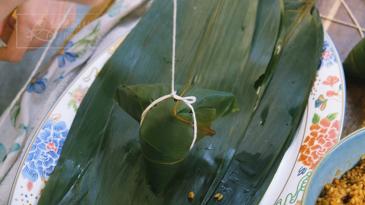 Image of Tie the zongzi with kitchen twine. Just a few cycles, and it should be secured. This recipe is enough to make 12-15 zongzi sp continue to wrap the rest.