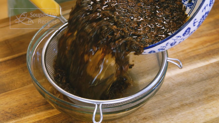 Image of Soak the Meigancai with water for 15 minutes to reduce...