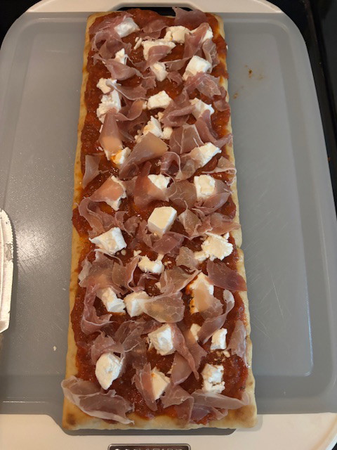 Image of Gently break apart Goat Cheese into small chunks and evenly distribute over the sauce.