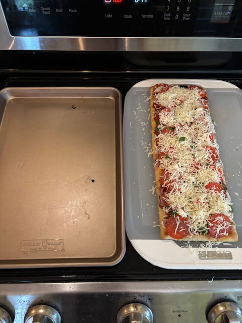 Image of Remove hot cookie sheet from oven using oven mitts and...