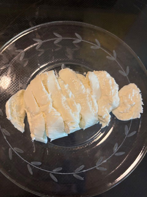 Image of Drain liquid from the Burrata container and slice each ball...