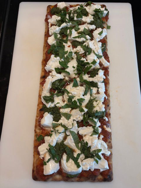 Image of Sprinkle the sliced Basil Leaves evenly onto the pizza.
