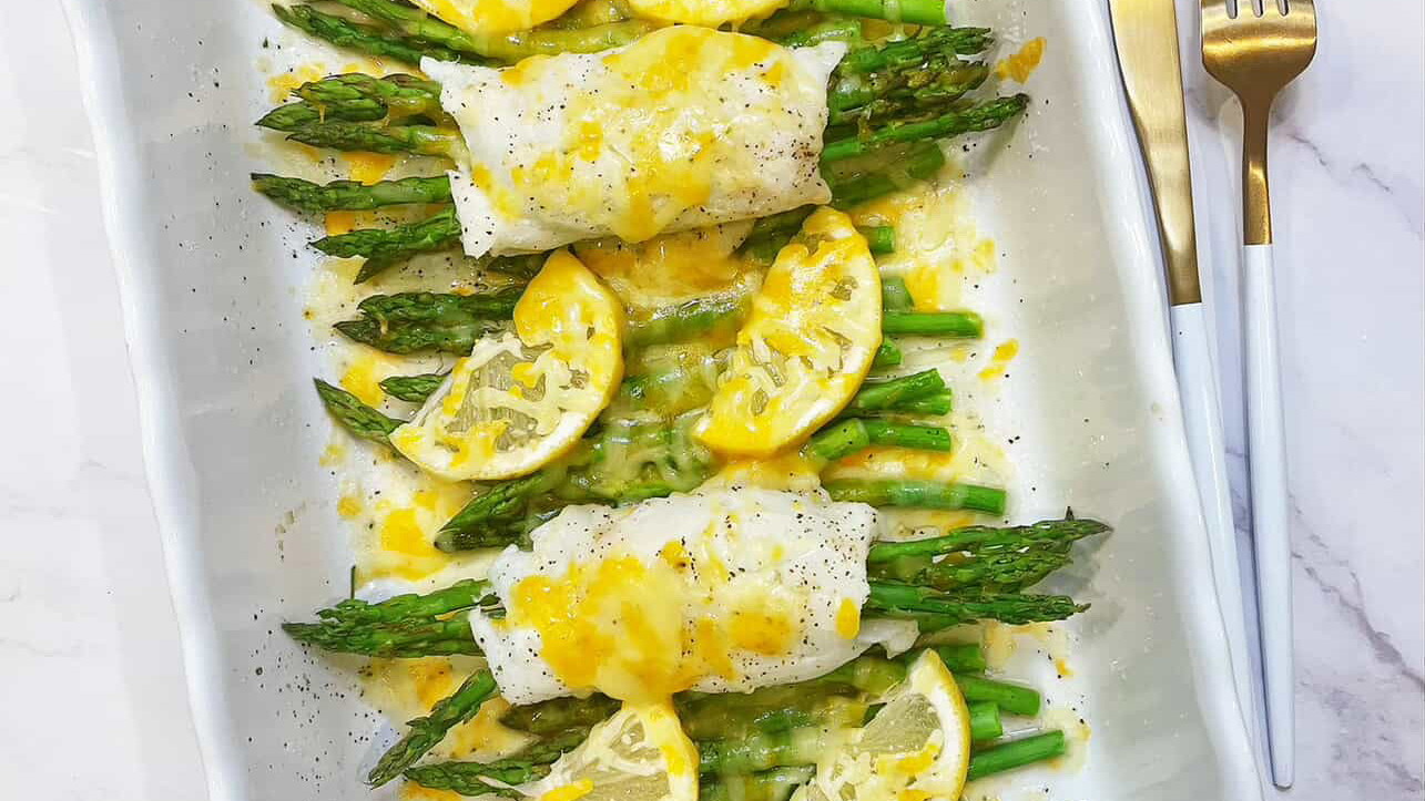 delicious plate of asparagus stuffed halibut with fresh lemon