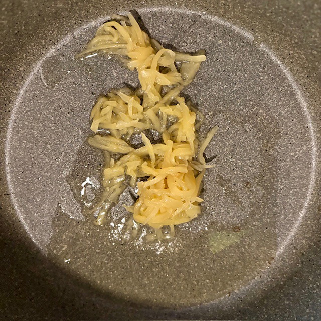 Image of Add 2 Tbsp Avocado Oil to a large non-stick skillet or wok and heat to medium-high heat (#7 on our stove-top). Once hot, add the grated Ginger and cook for 1 minute.