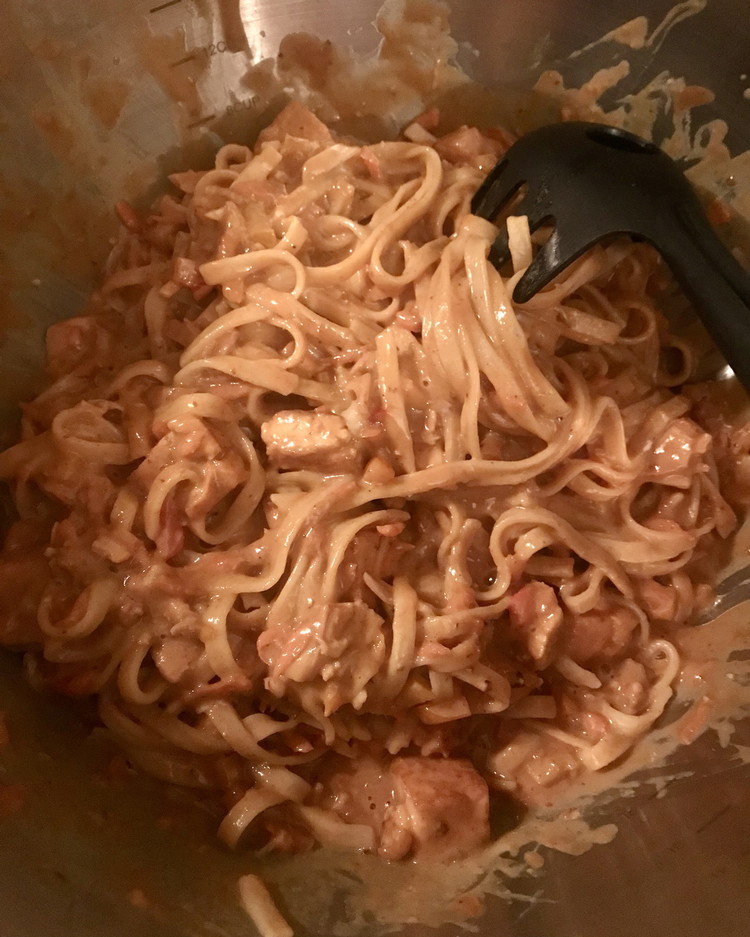 Image of In a large mixing bowl, toss the cooked noodles with the Peanut Sesame Sauce. Then add the pan-fried tofu and other ingredients and gently combine.