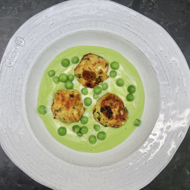 Image of chicken meatballs over peas and creme fraiche