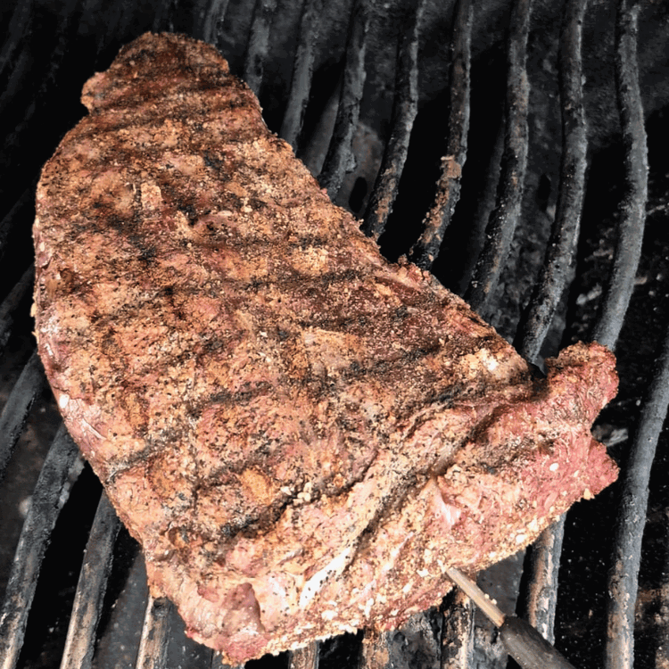 Image of Once the grill is sufficiently heated, sear the steak, flipping...