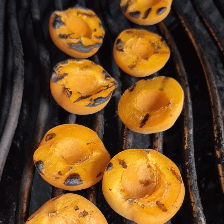 Image of While the grill is preheating, place the halved apricots on the grate and allow them to char, flip, and do the other side. Allow to cool and then slice into wedges.