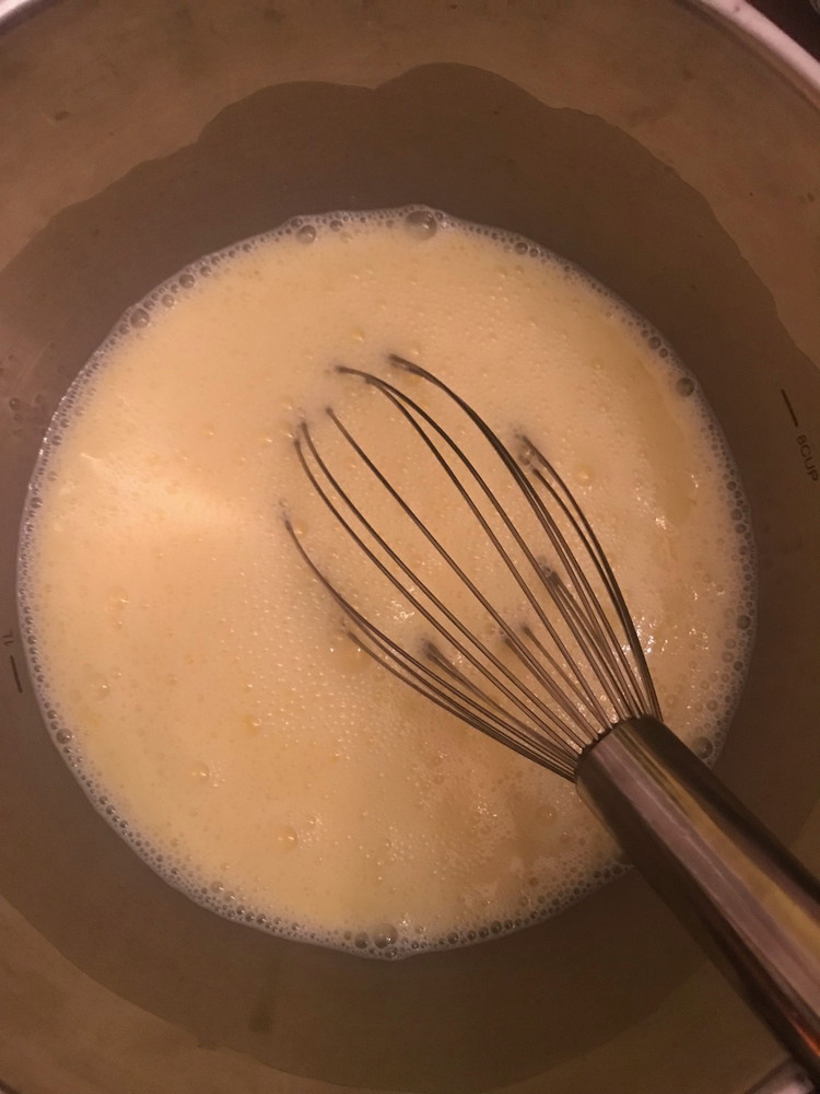 Image of In a large bowl, whisk together the eggs and milk.