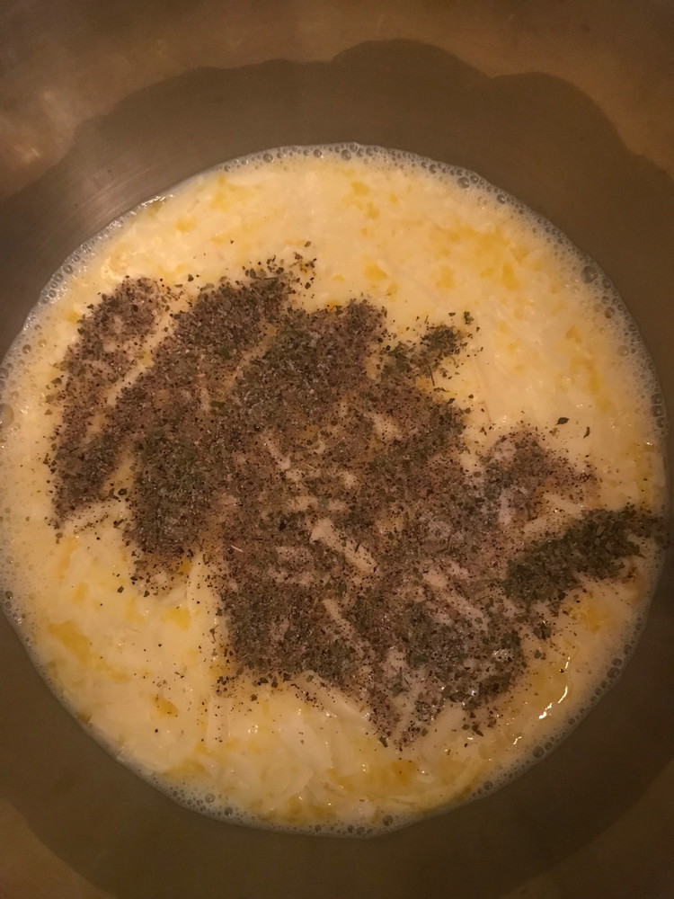 Image of To the bowl, add the grated cheese, minced garlic, oregano, celtic salt, black pepper and whisk together.