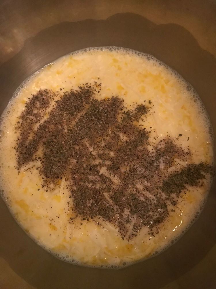 Image of To the bowl, add the grated cheese, minced garlic, oregano,...