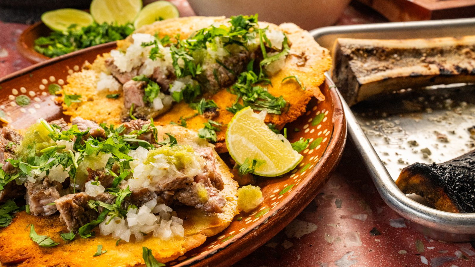 Death Bed Tacos topped with onion, cilantro, and salsa verde