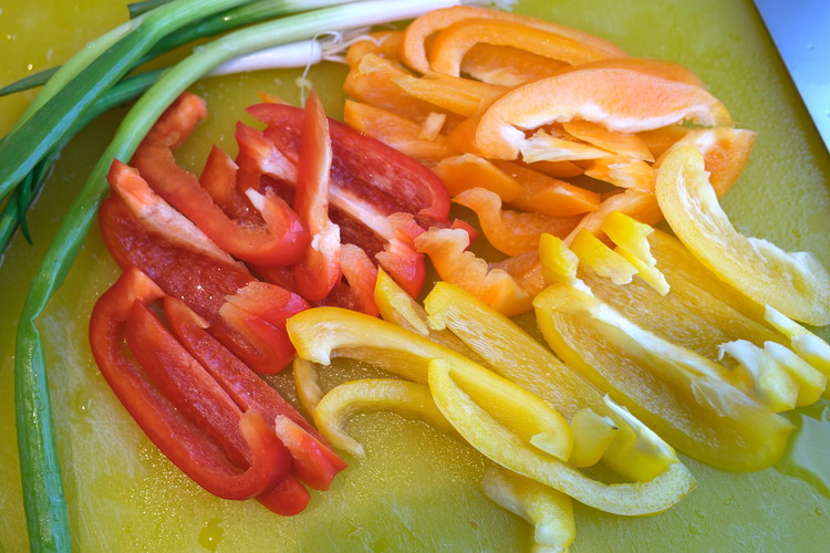 Image of While pasta boils slice your peppers in thin long slices. I think using half of each bell pepper for this recipe is plenty (save the rest for a different purpose).