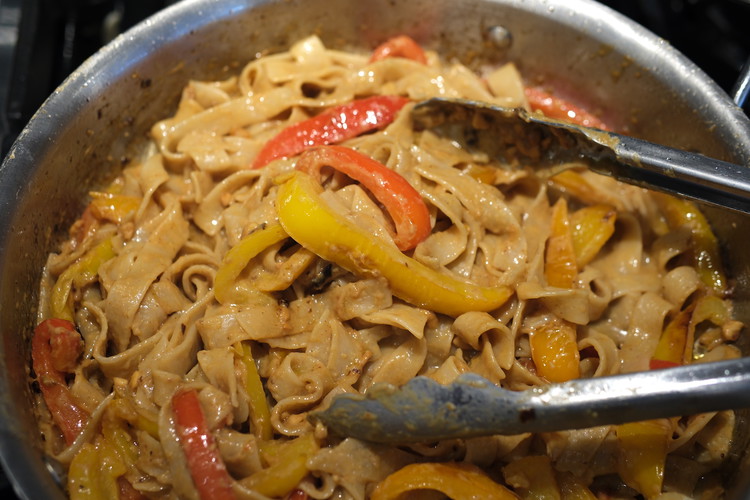 Image of Add in the drained cooked pasta, peanut sauce, and start to add some water (pasta water or just cold water) and blend well together.  Start with 1/3 of cup and keep adding as needed.  You want the pasta to have...