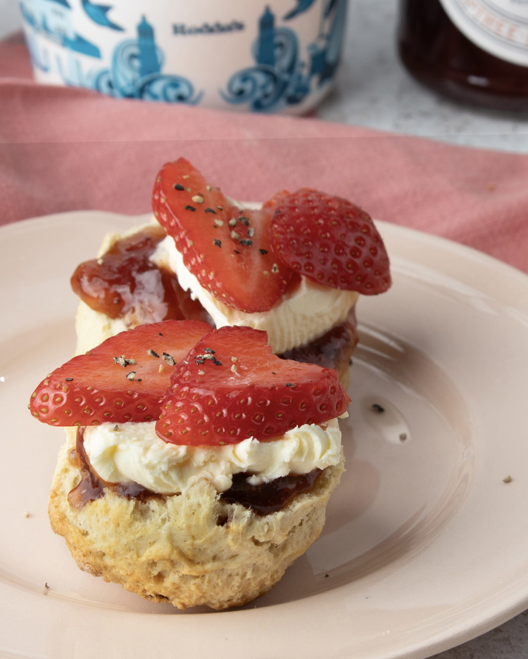 Image of Serve with Tiptree East Anglian Strawberry Conserve, sliced strawberries sprinkled with a little extra black pepper and Rodda’s Clotted Cream.