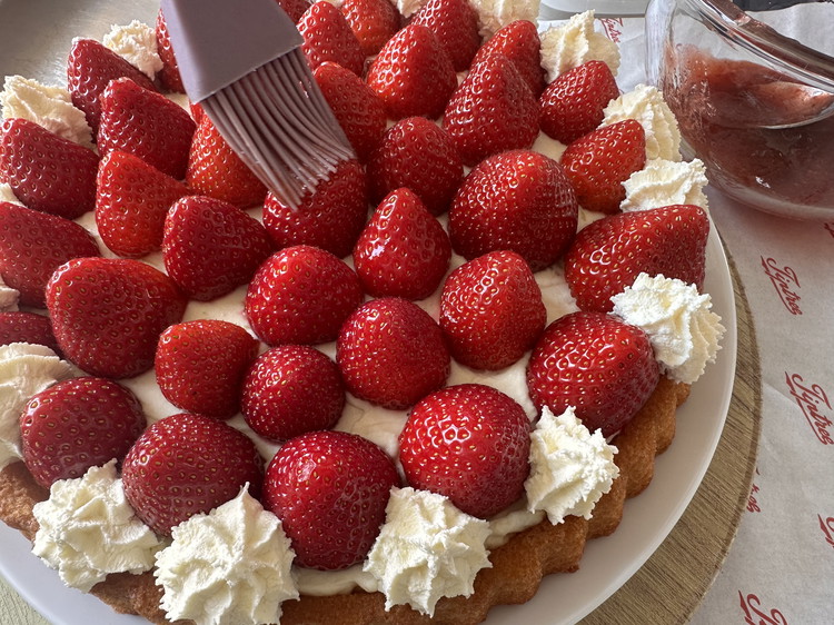 Image of Brush the top of each strawberry with a little sieved Strawberry Conserve.