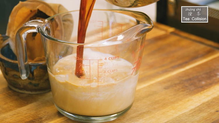 Image of Add one can of evaporated milk into the measuring cup or a pitcher. Then, pour in the tea from a high position. This process is called 撞茶, which translates as tea collision. It helps fully blend the tea and milk, creating...