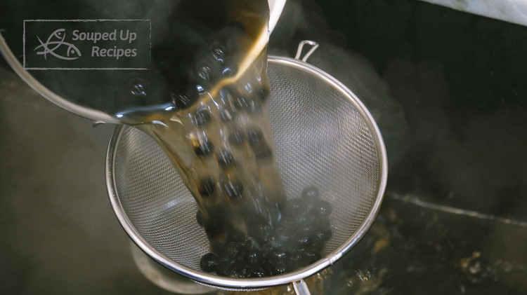 Image of Once done, pour the pearls into a sieve to drain and rinse under cold water to remove excess starch.