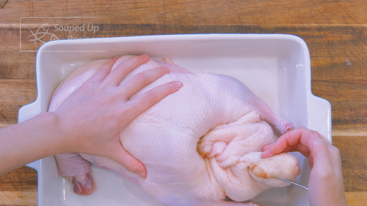 Image of The next step is to seal the duck. Grab the opening of the cavity and stick a metal skewer in, twisting it over tightly and stitching it in again. Repeat that step until there is no more opening. When you...