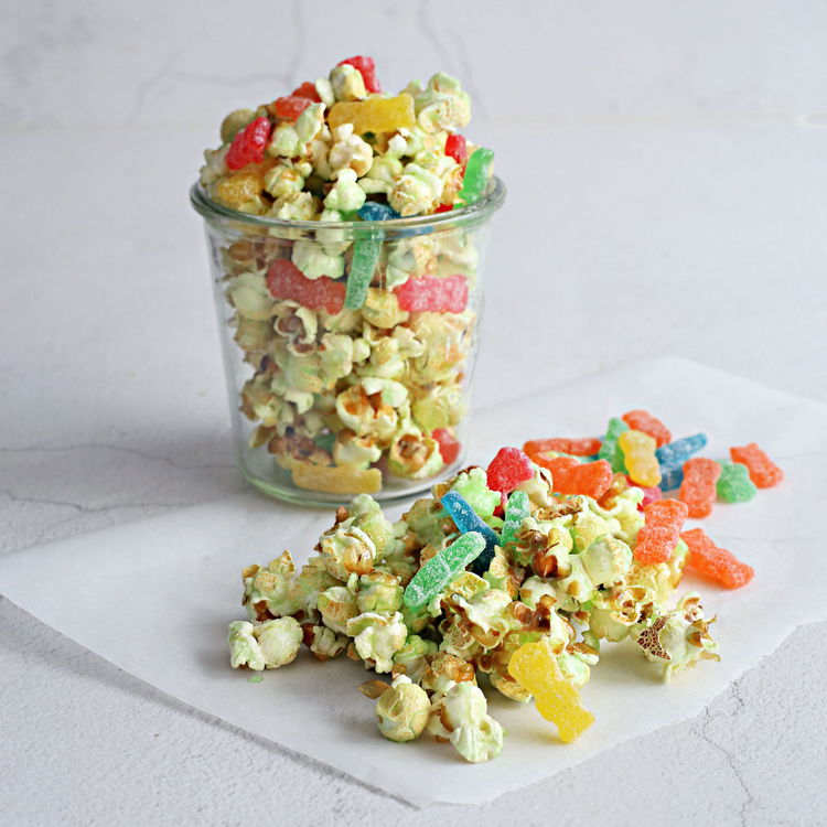 Image of Pour candy mixture over popcorn, stirring to coat. Spread on...
