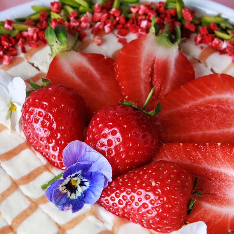 Image of Sprinkle with slivered or chopped pistachios and top with sliced strawberries.