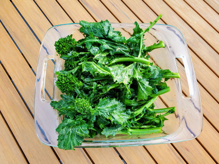Image of Mix a drizzle of olive oil, finely grate garlic and red pepper with broccoli rabe.  You are just trying to get a coating for grilling.  I find it easier to use my hands for this to really spread the garlic