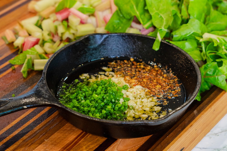 Image of Take a small heavy bottomed pan and add in about a ¼ cup of oil. Add your garlic, pepper flakes, and chives and place over low heat until just simmering. You want this to go as slow as possible so...