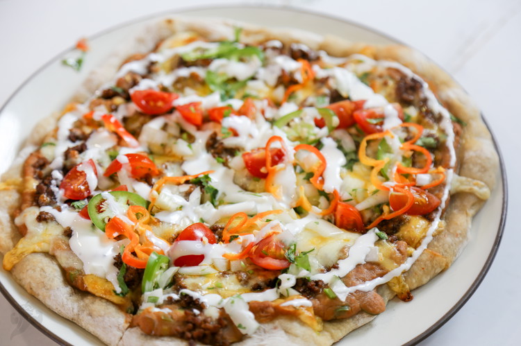 Image of Add cold toppings to your hearts desire and slice. This includes lettuce, tomato, peppers, onions, cilantro, avocado, and crema/sour cream.   Enjoy your new obsession. 