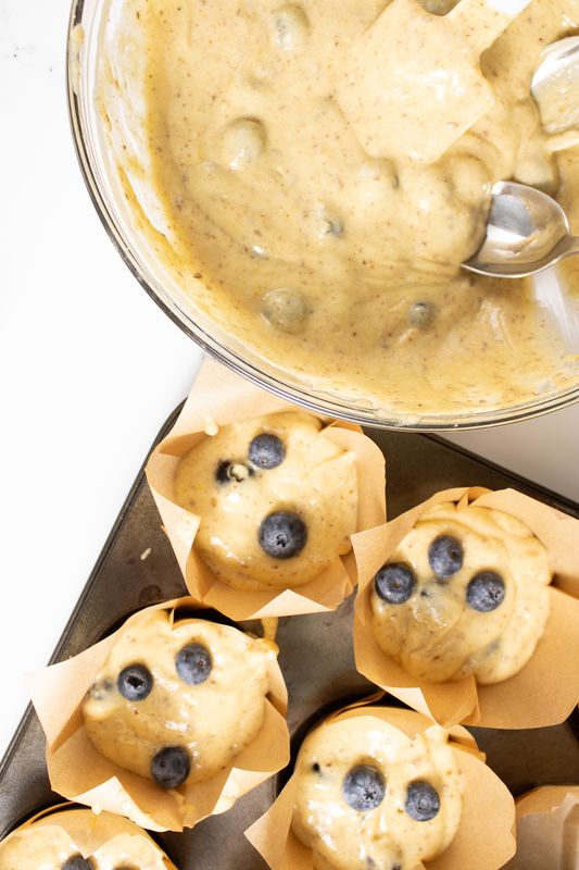 Image of Spoon into muffin tin.