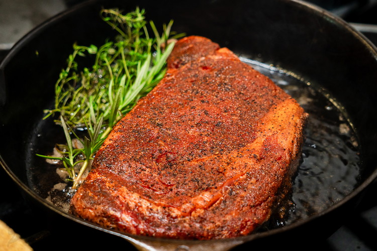 Image of Add herbs and butter to the pan and using a spoon, spoon the butter and oil over the top of the steak. Arroser is the french culinary term used to describe this method and it just means to baste. Flip...