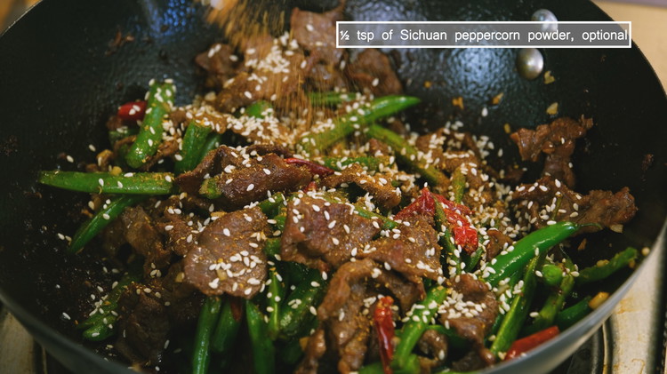 Image of Introduce the green beans back to the wok and sprinkle some toasted sesame seeds and Sichuan peppercorn powder. Toss well and you are done.