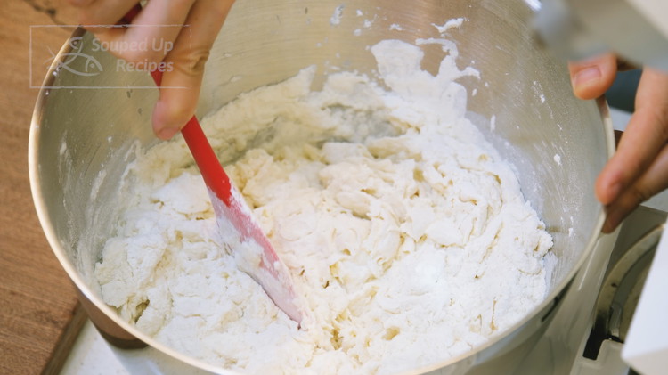 Image of Add the all-purpose flour and mix with a rubber spatula until all the water is well absorbed. Every brand of flour has a different water-absorbing rate, so you have to adjust the measurement depending on your situation.