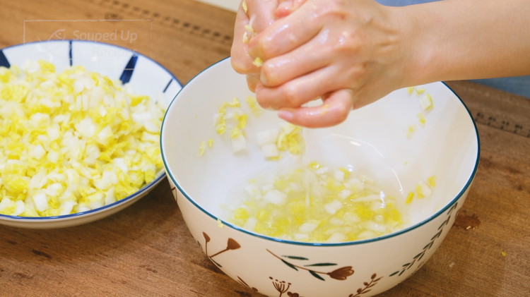 Image of Squeeze most of the water. We use 400g of cabbage; after the squeeze, you should have about 250g of cabbage left. Set it aside for now.