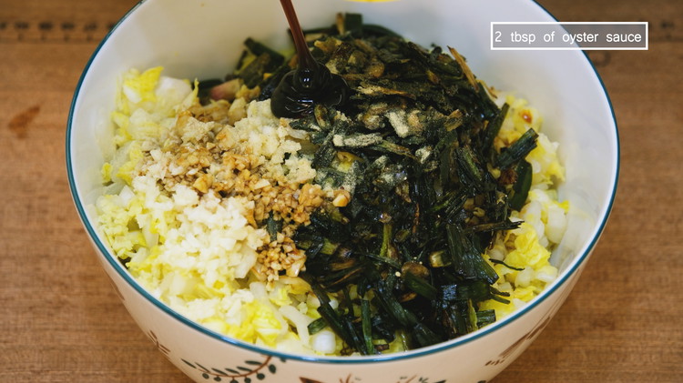 Image of Combine the scallions and oil with the squeezed cabbage and the ground pork. Continue by adding 2 tsp of minced ginger, 2 Tbsp of minced garlic, 1/2 tsp of white pepper powder or to taste, 2 tbsp of soy sauce,...