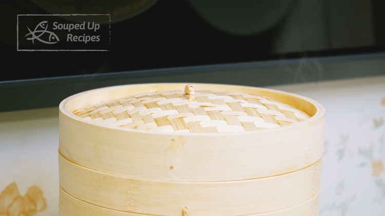 Image of Place the steamer onto a pot that is filled with water. Turn the heat to high and bring the water to a boil. Once you can see the steam coming out, switch the heat to medium and start counting the...