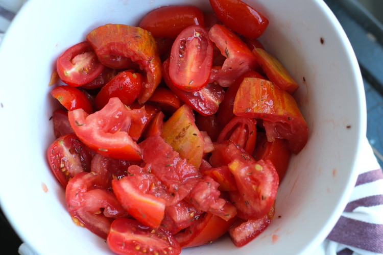 Image of Prepare tomatoes, put them in a bowl with salt and cumin.  Stir well and let sit for about 10 to 15 minutes.  You are trying to get the tomatoes to toss out their water (which you want for a later...