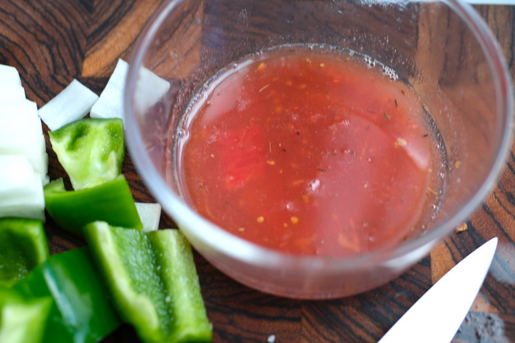 Image of Drain the tomato ‘water’ that the tomatoes have tossed off into a small bowl. Add the California Sherry Vinegar to the tomato water