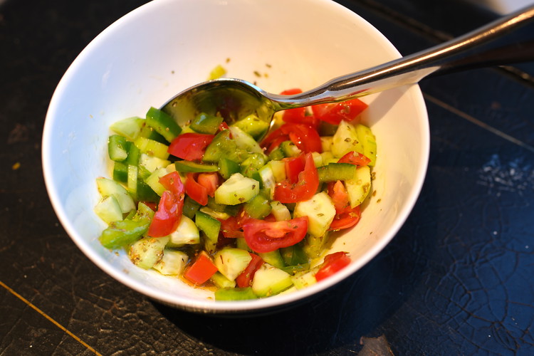 Image of Optional:  Make topping to spoon on before serving.  Adds some texture and makes it more visually interesting.  All you do is finely chop a little bit of onion, green pepper, tomato, cucumber and mix it all with some oregano, salt,...