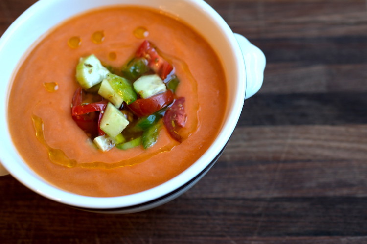 Image of Plate: Taste you refrigerated gazpacho. Adjust salt and vinegar as/if needed. If you want it more liquidy add a small amount of ice water. Serve it in a bowl with some of the topping and a drizzle of olive oil...