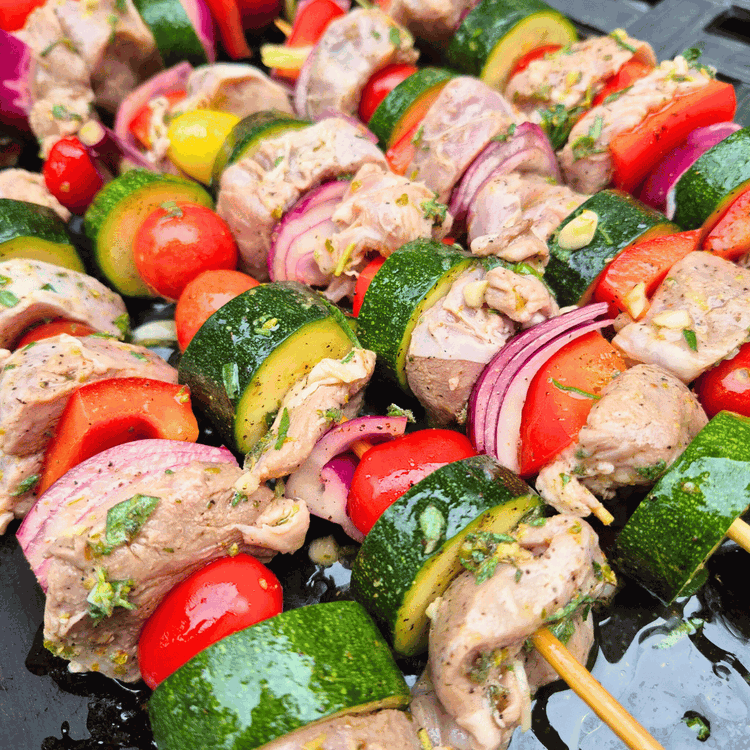 Image of Carefully skewer the marinated boar onto soaked skewers.