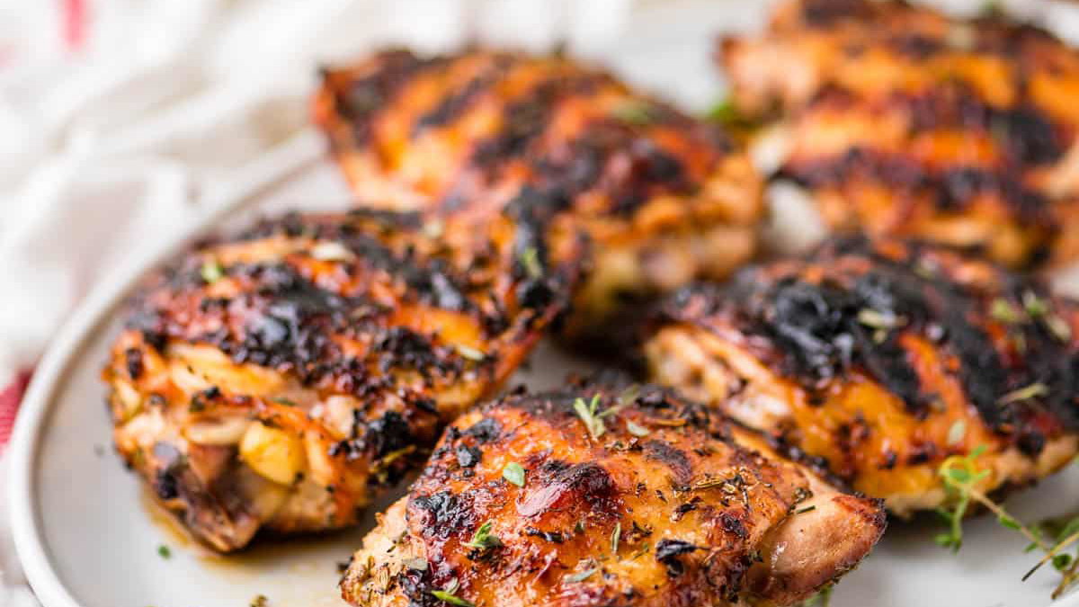 Crispy roasted chicken thighs with glaze and sweet heat seasoning on a tray